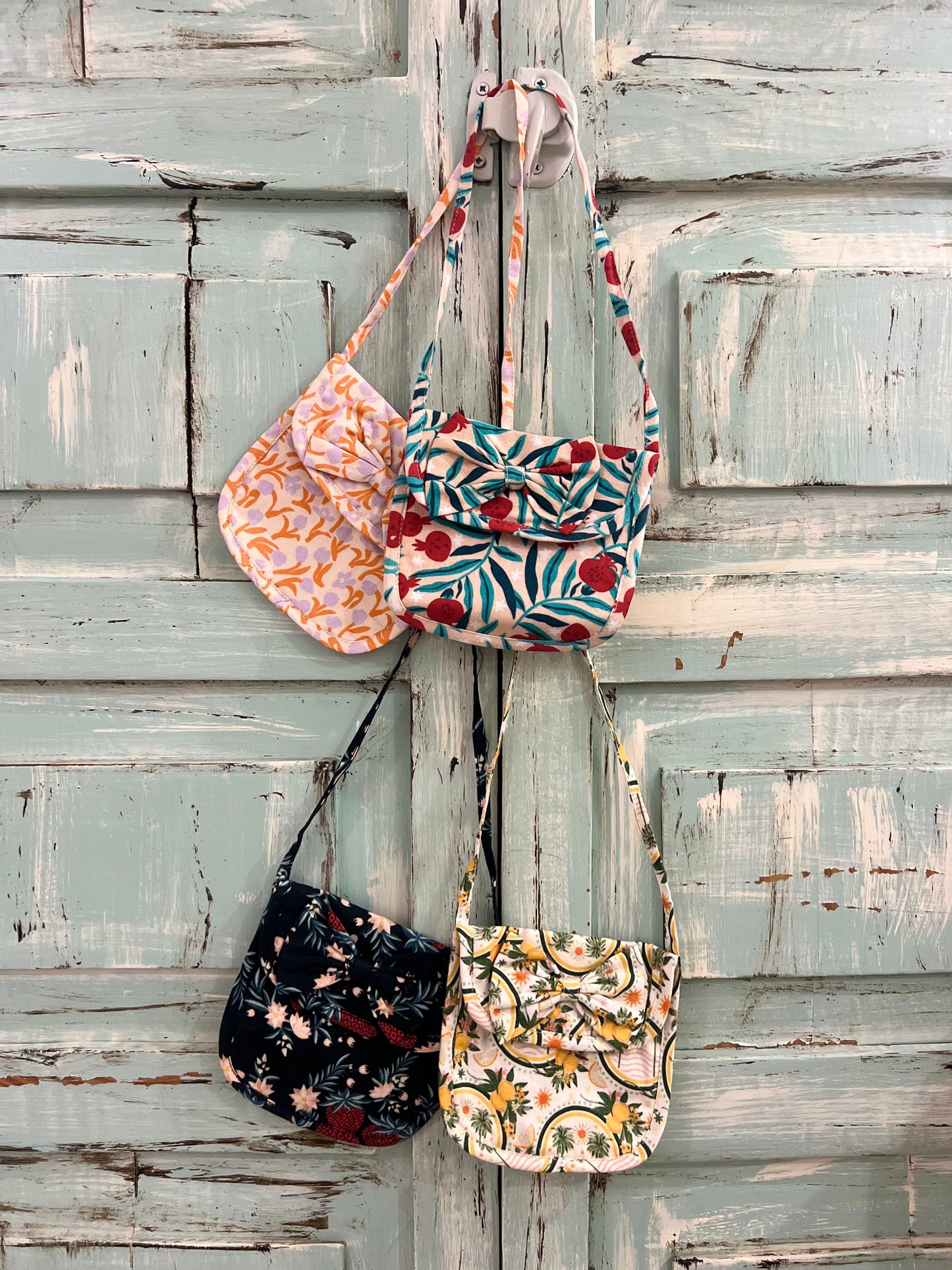 small fabric shoulder bags with floral and botanical prints, each featuring unique color and pattern